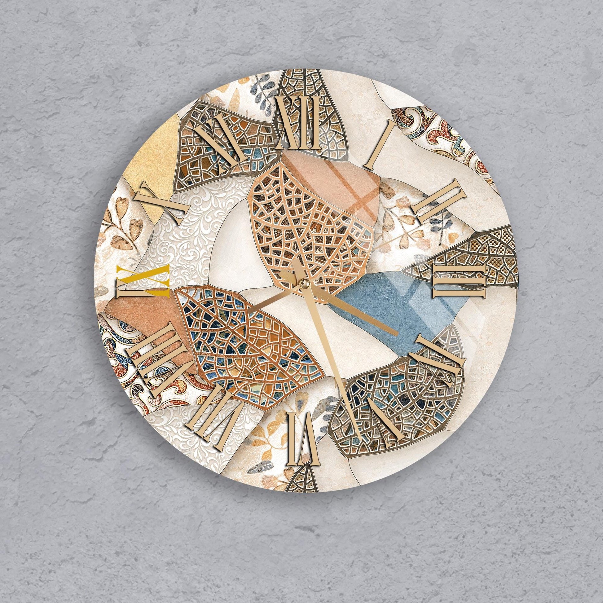 a round clock with a mosaic design on its face, set against a gray background.