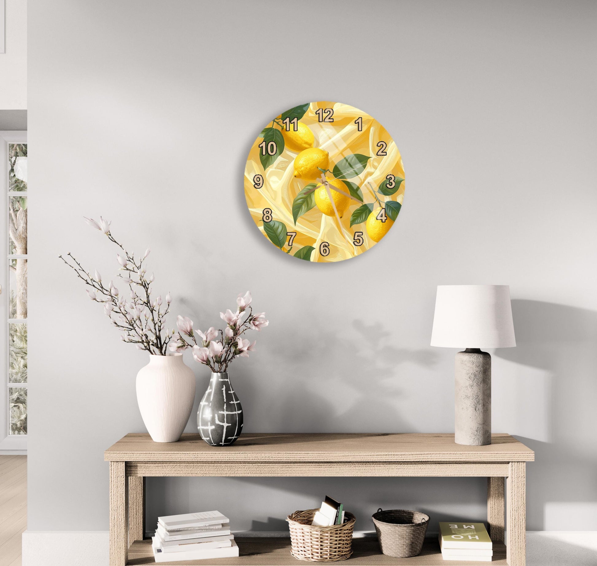 a wall clock with a lemon design, a wooden table with a vase of flowers, a lamp, and some books on a shelf.
