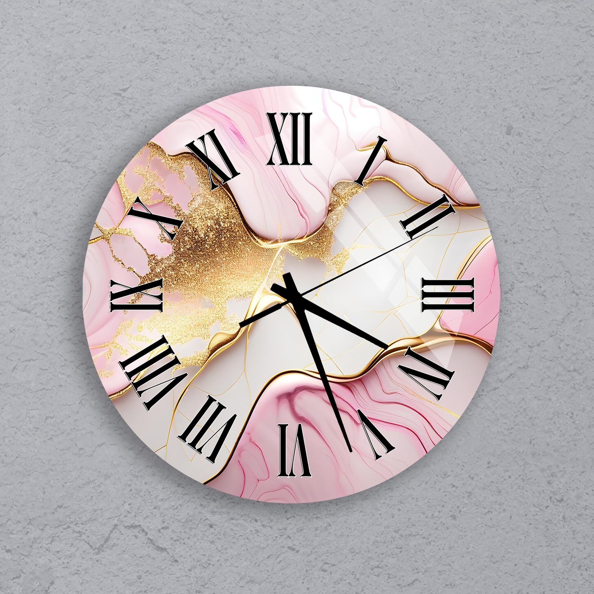 A round wall clock with a pink marble-like design and gold glitter accents.