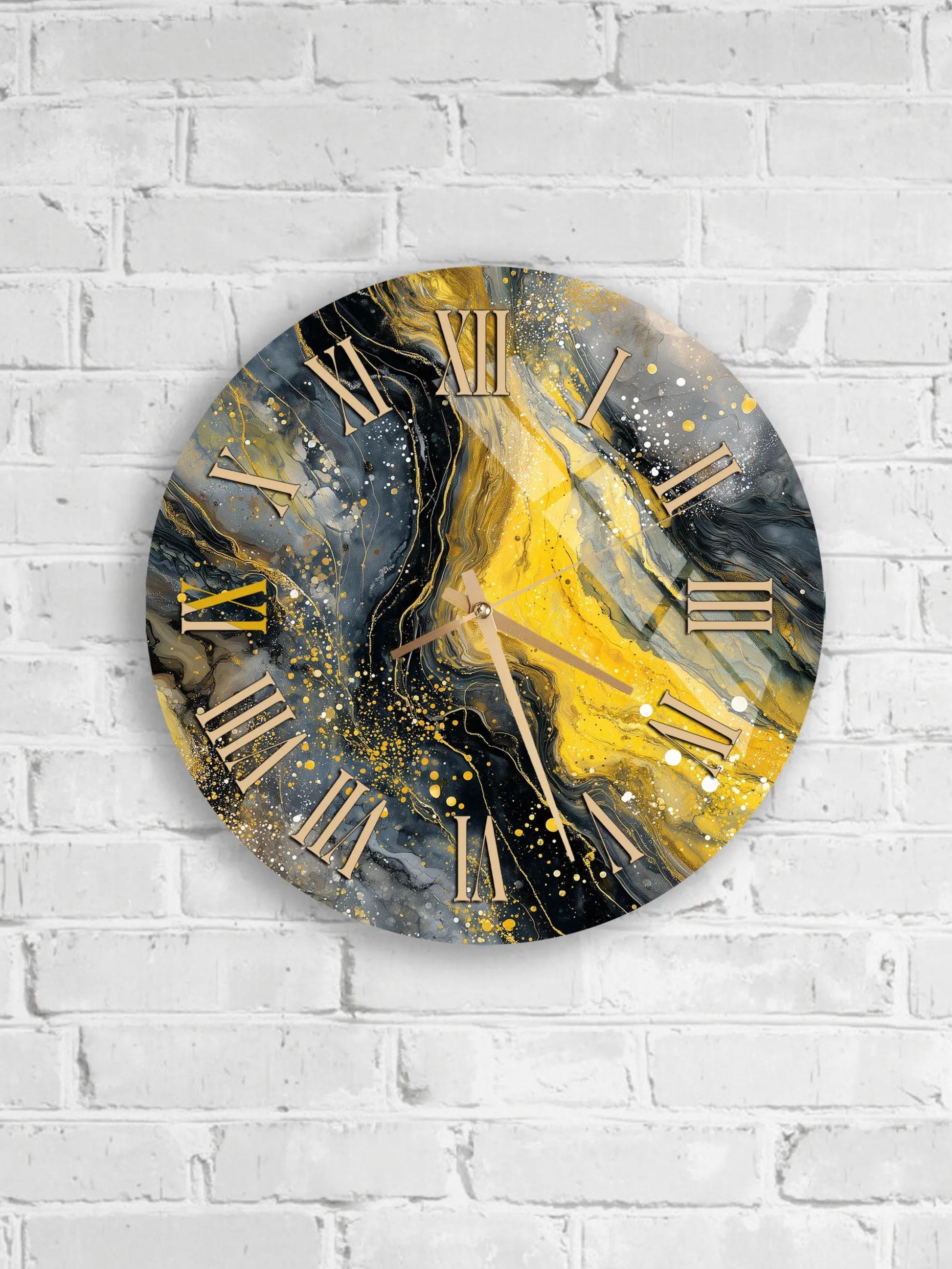 A round wall clock with a gold and black marble design, featuring Roman numerals and a swirling pattern of yellow and black paint.
