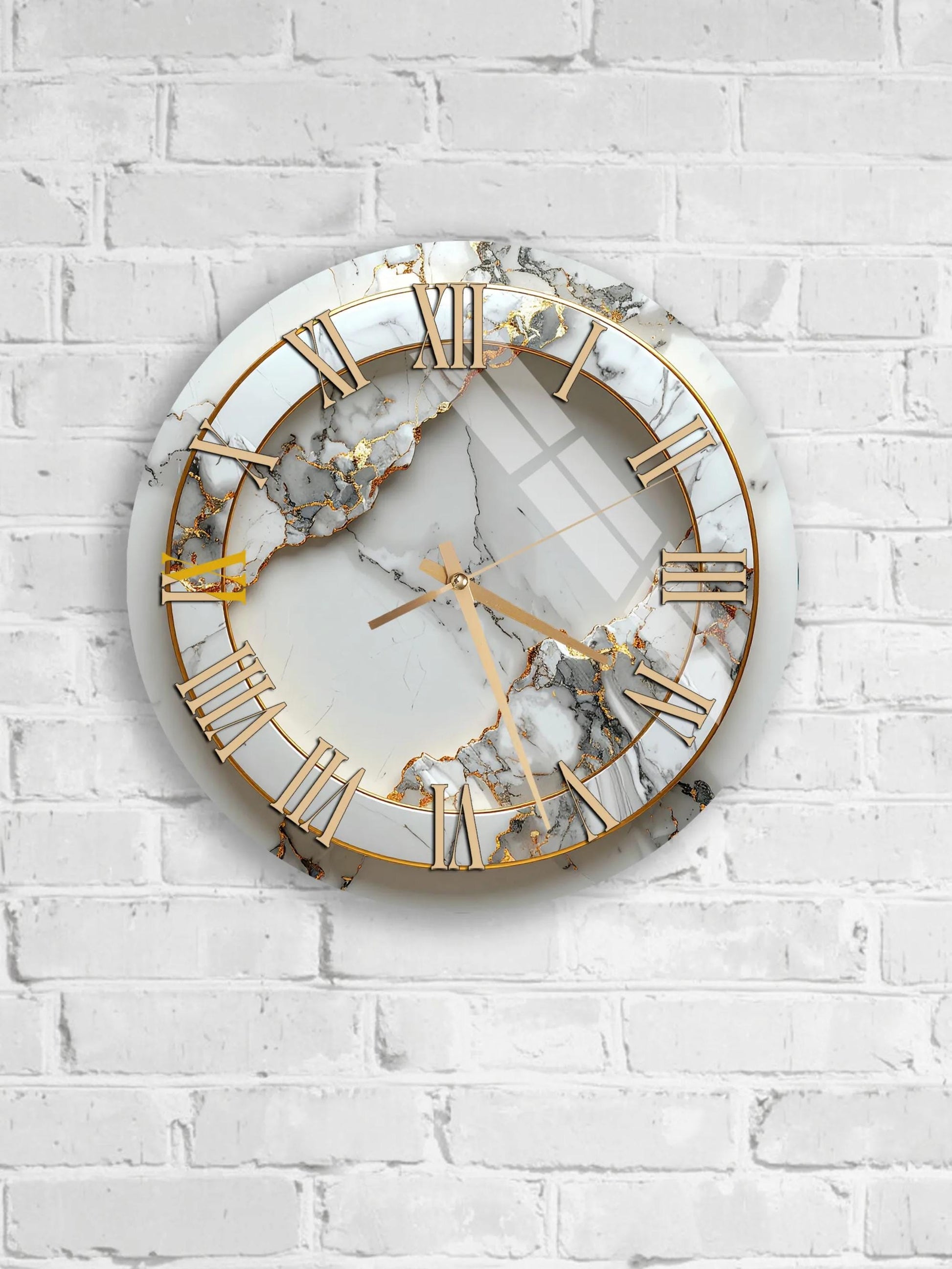 A white marble clock with gold Roman numerals is mounted on a white brick wall.