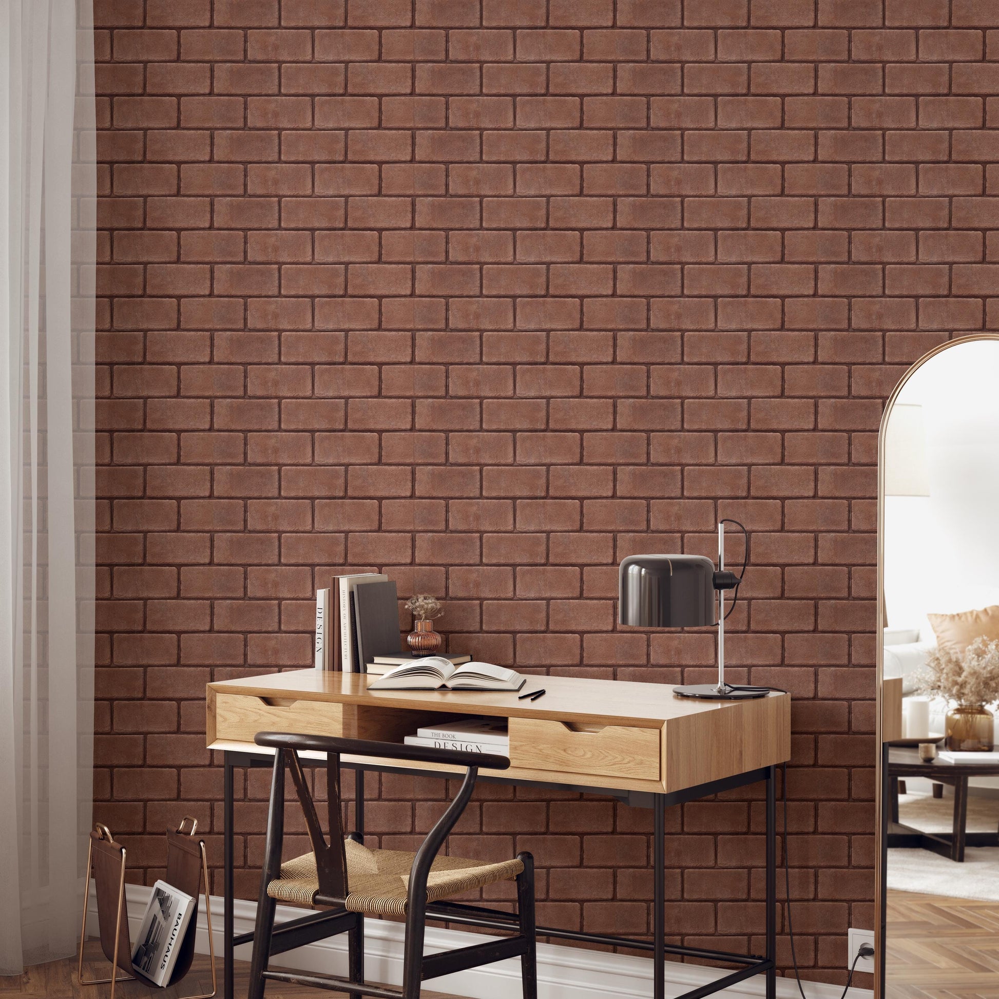a modern workspace with a wooden desk, a black lamp, and a bookshelf against a brick wall.