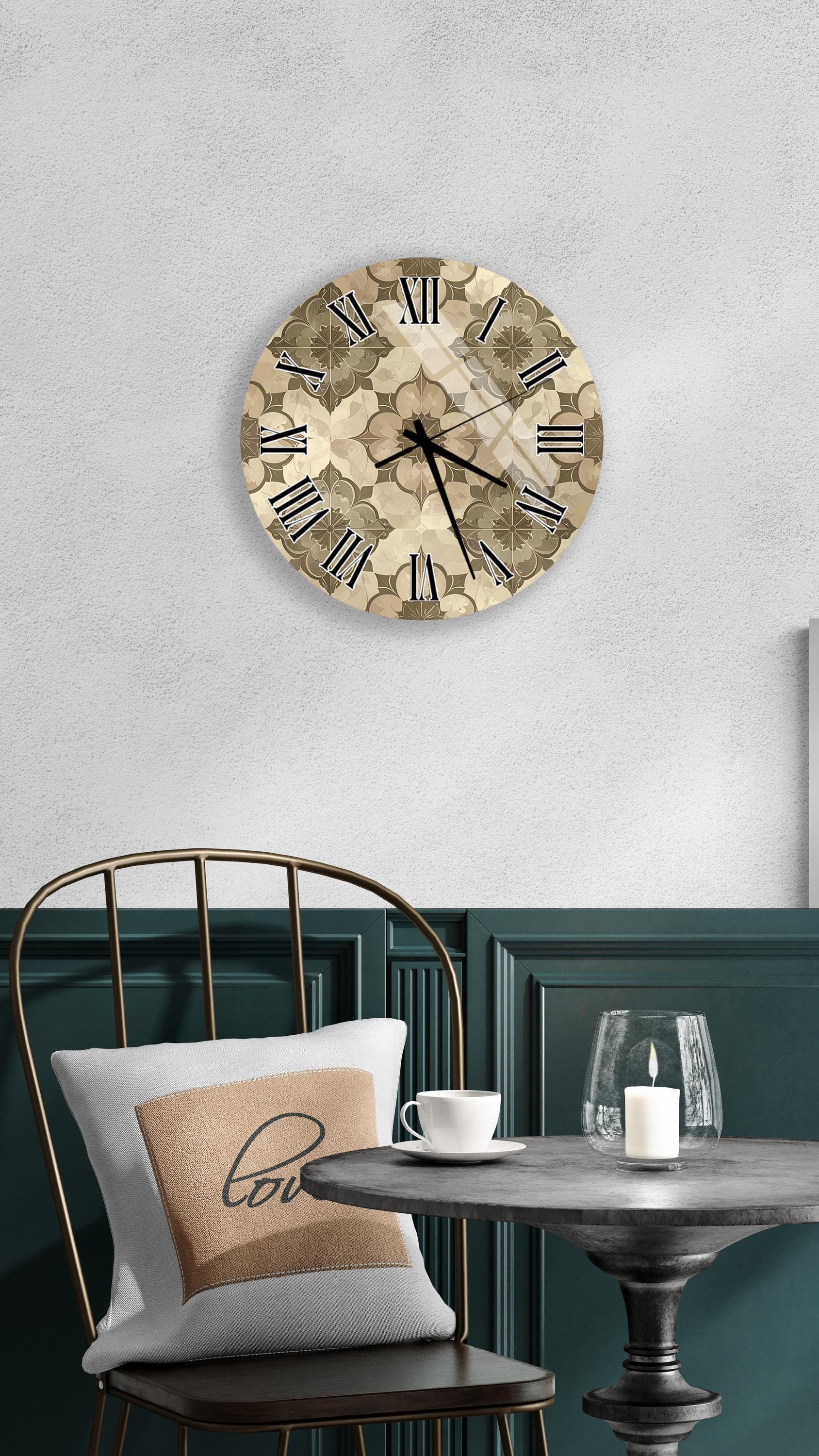 a wall clock with a floral design, a round table with a white cup and a lit candle, and a chair with a pillow on it.