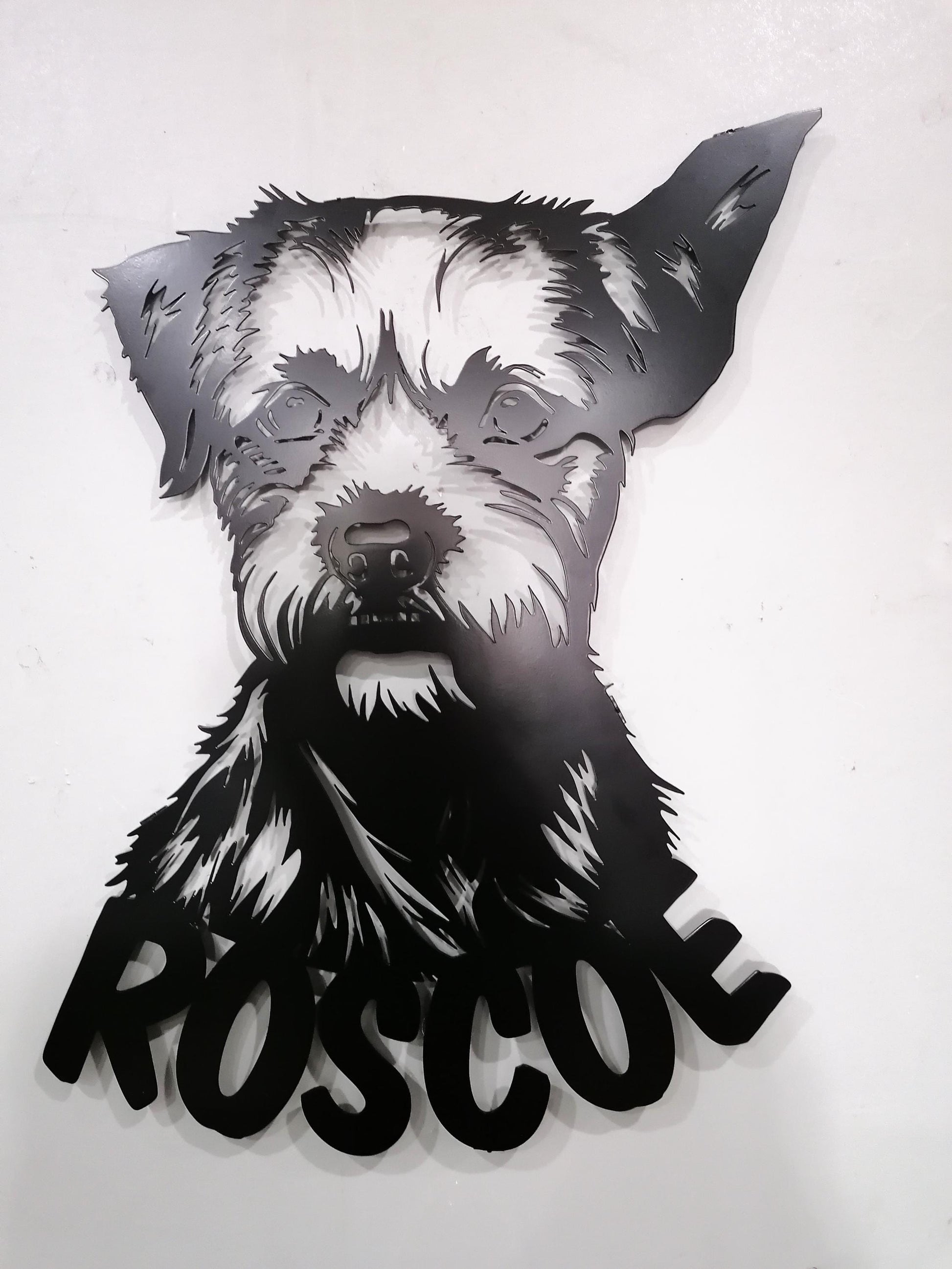 a black and white picture of a dog on a white wall