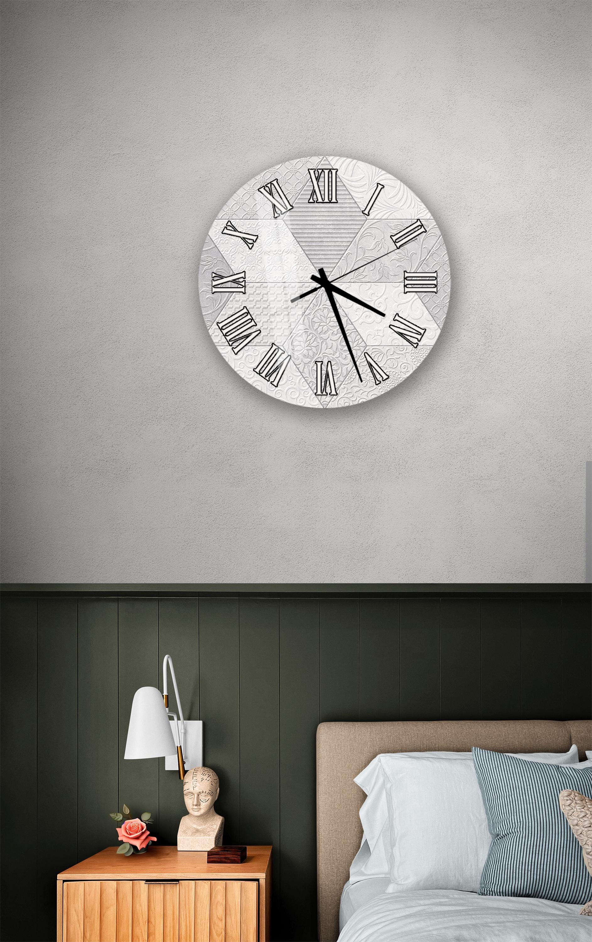 a bedroom setting with a large wall clock, a wooden nightstand, and a bed with white bedding.