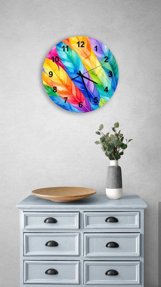 a wall clock with a vibrant feather design, mounted on a wall above a light blue dresser with six drawers. The dresser also has a small plant and a wooden bowl on it.