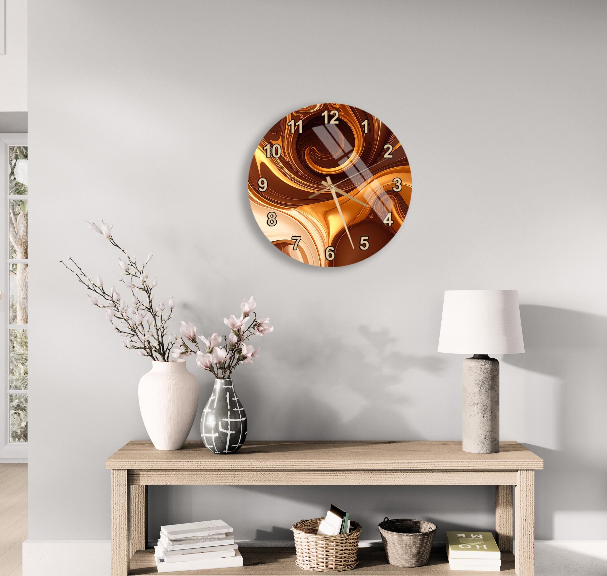 a modern living room with a wooden console table, a round wall clock with a swirling design, a white vase with pink flowers, and a white lamp on the table.