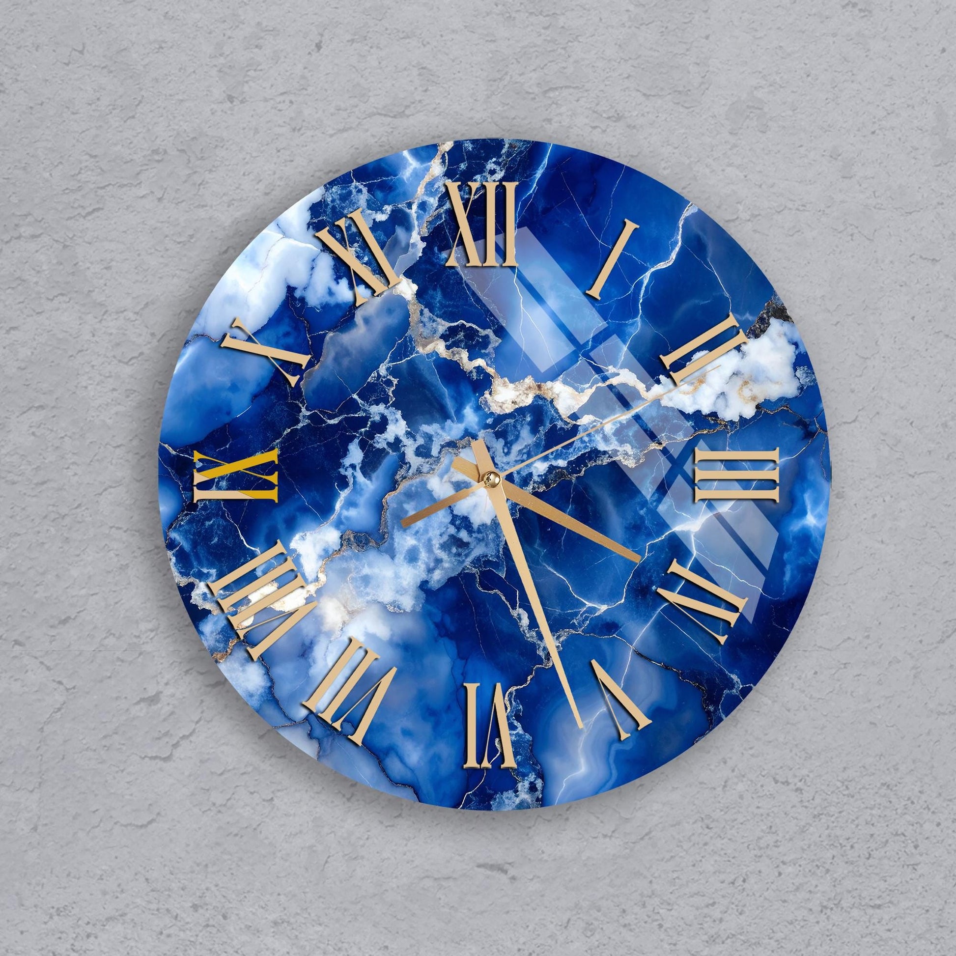 A round clock with a blue marble-like design and gold Roman numerals.