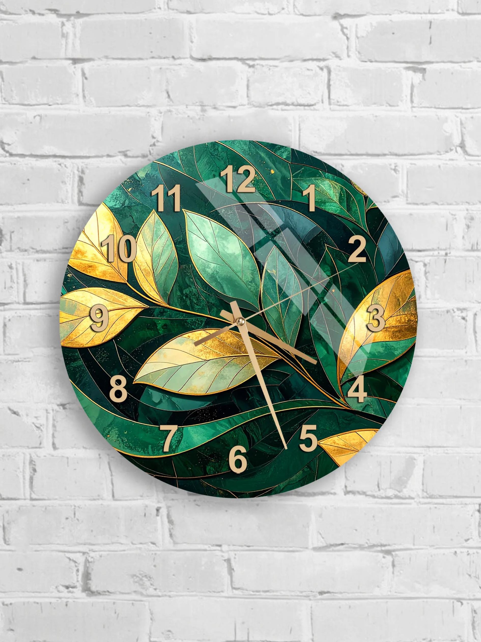 six round wall clocks with green leaf designs on a white brick wall.
