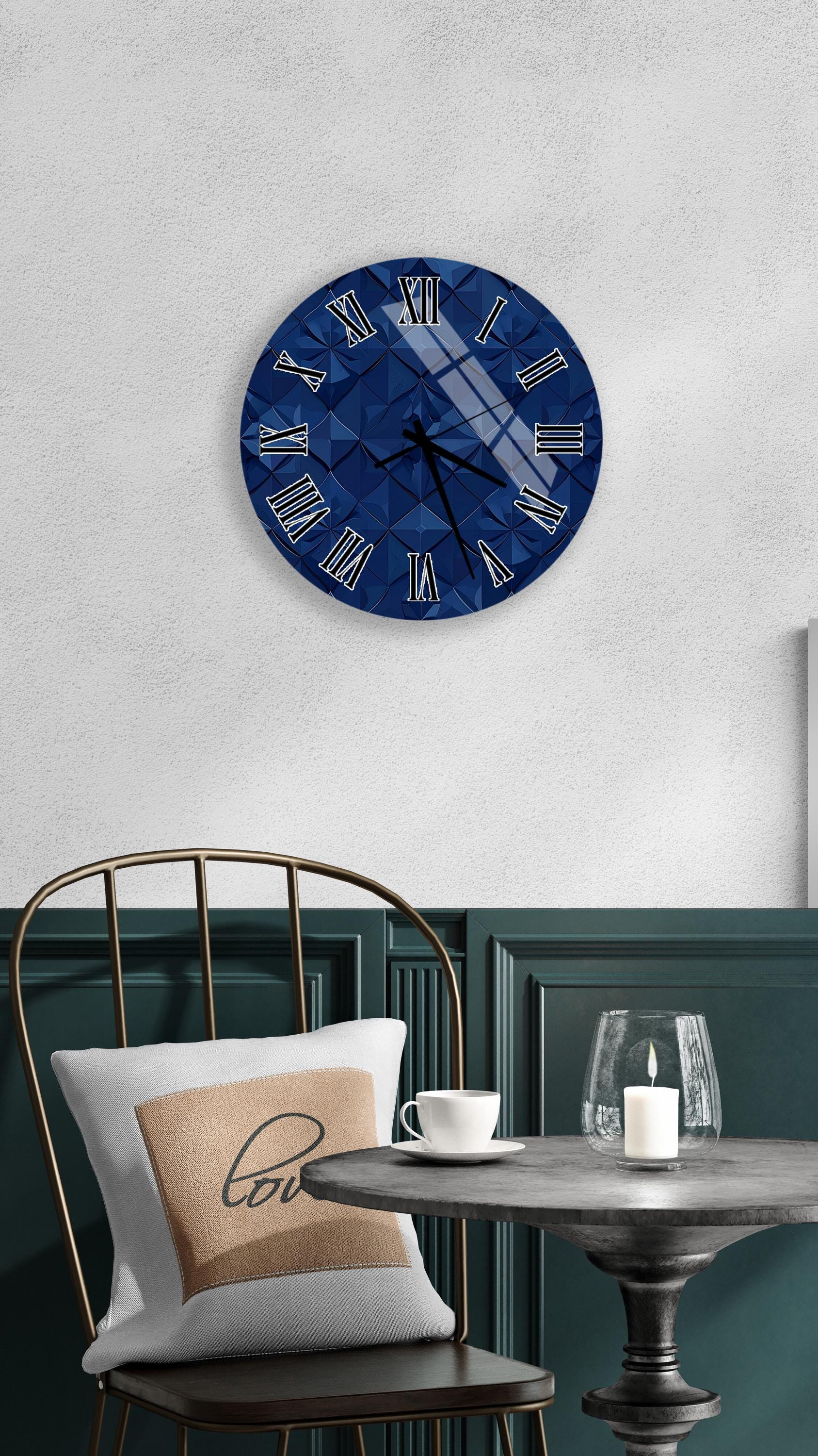 a modern interior design with a blue clock on the wall, a white table with a candle, and a gold chair.