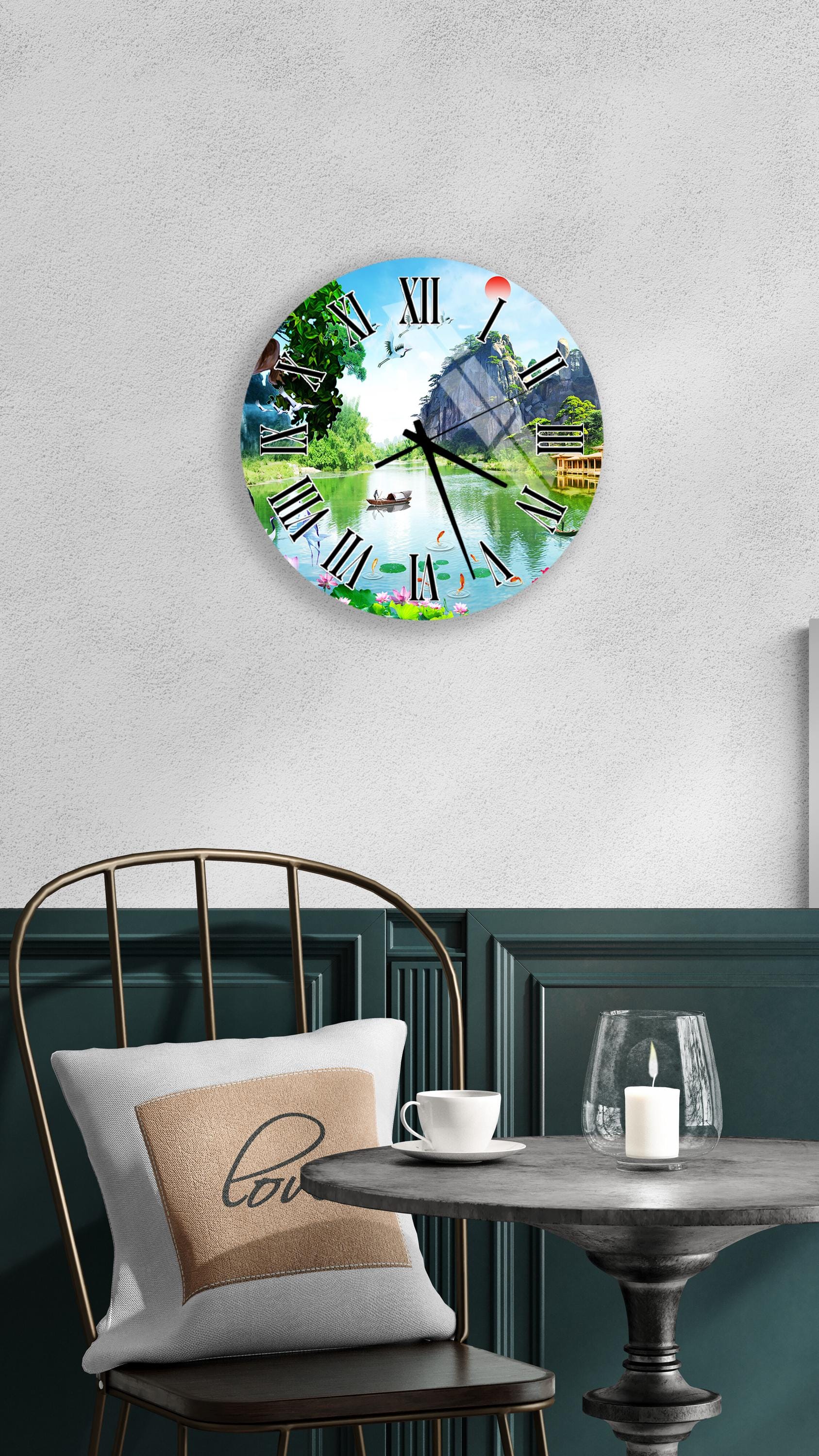 a round clock with a scenic landscape design on its face, mounted on a wall above a table with a white tablecloth.