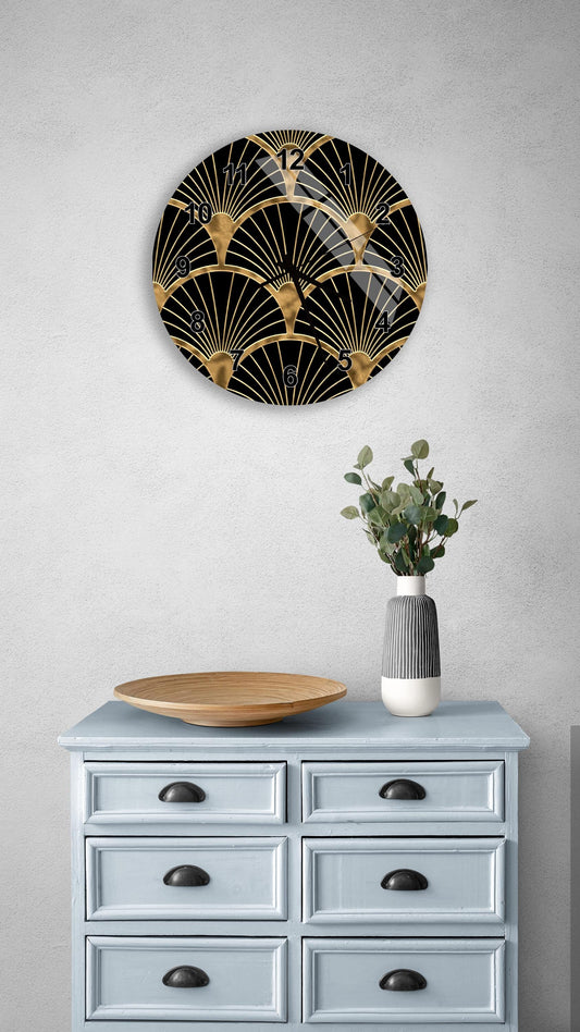 a wall clock with a black and gold design, mounted on a wall above a light blue dresser with six drawers. The dresser also has a vase with greenery and a wooden bowl on it.
