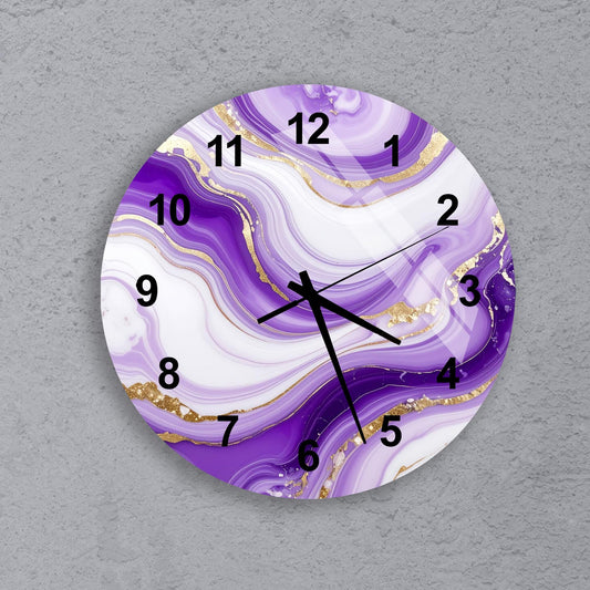 A wall clock with a purple and white marble-like design, featuring gold accents and black numbers.