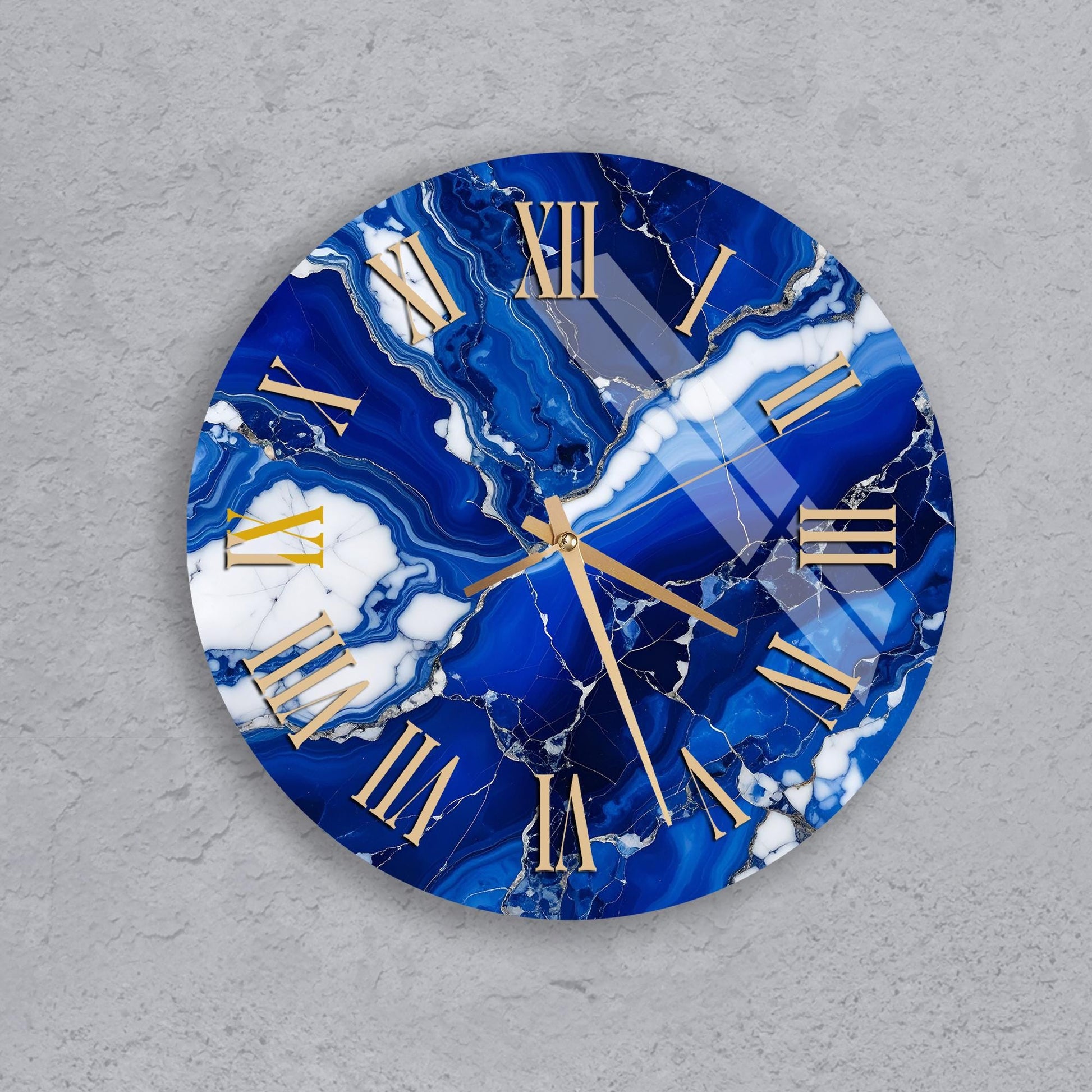 A round clock with a marble-like blue and white design, featuring gold Roman numerals.