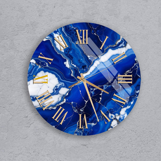 A round clock with a marble-like blue and white design, featuring gold Roman numerals.