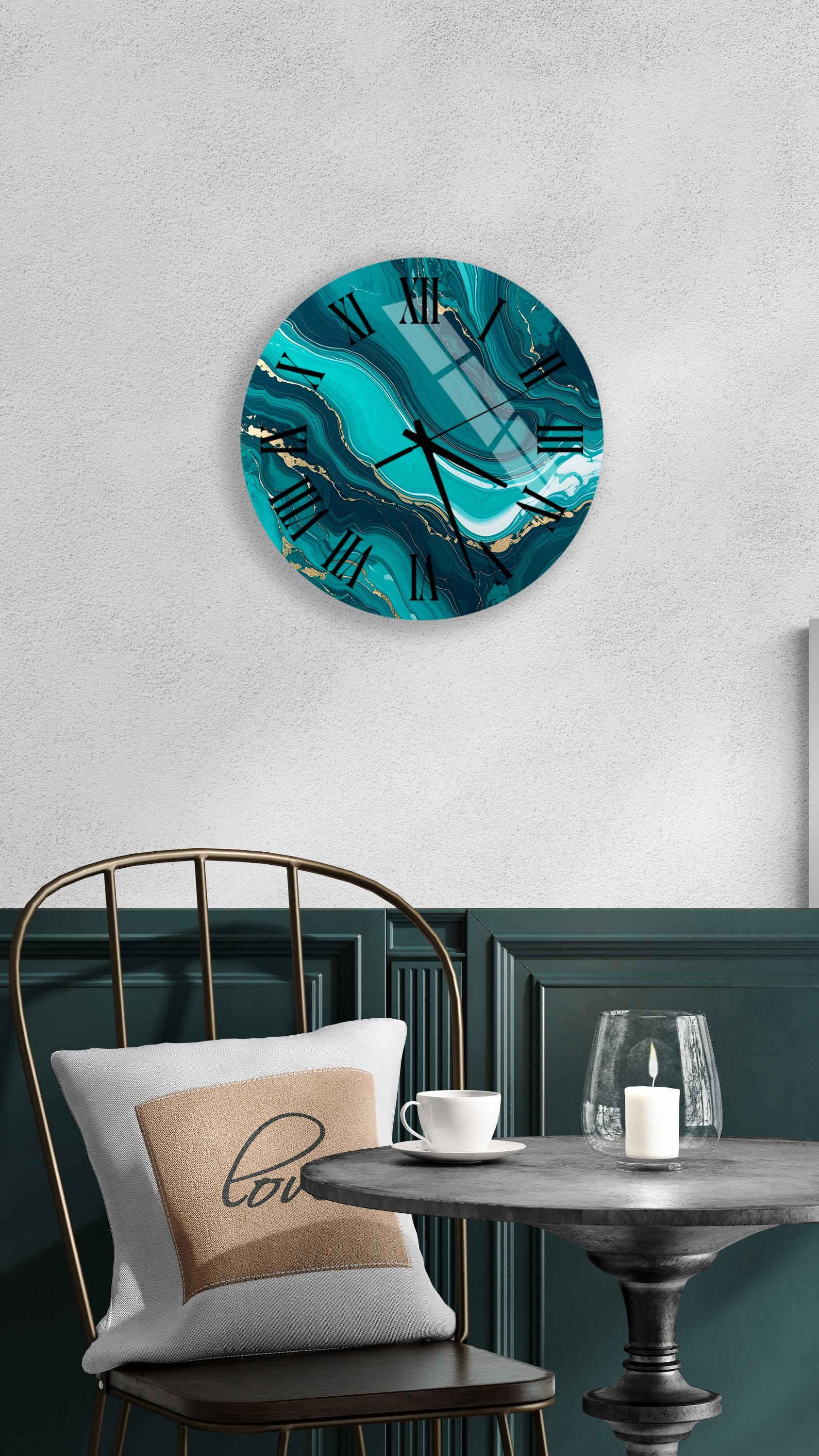 a modern and stylish interior design with a teal-colored wall clock, a white table with a candle, and a black metal chair.