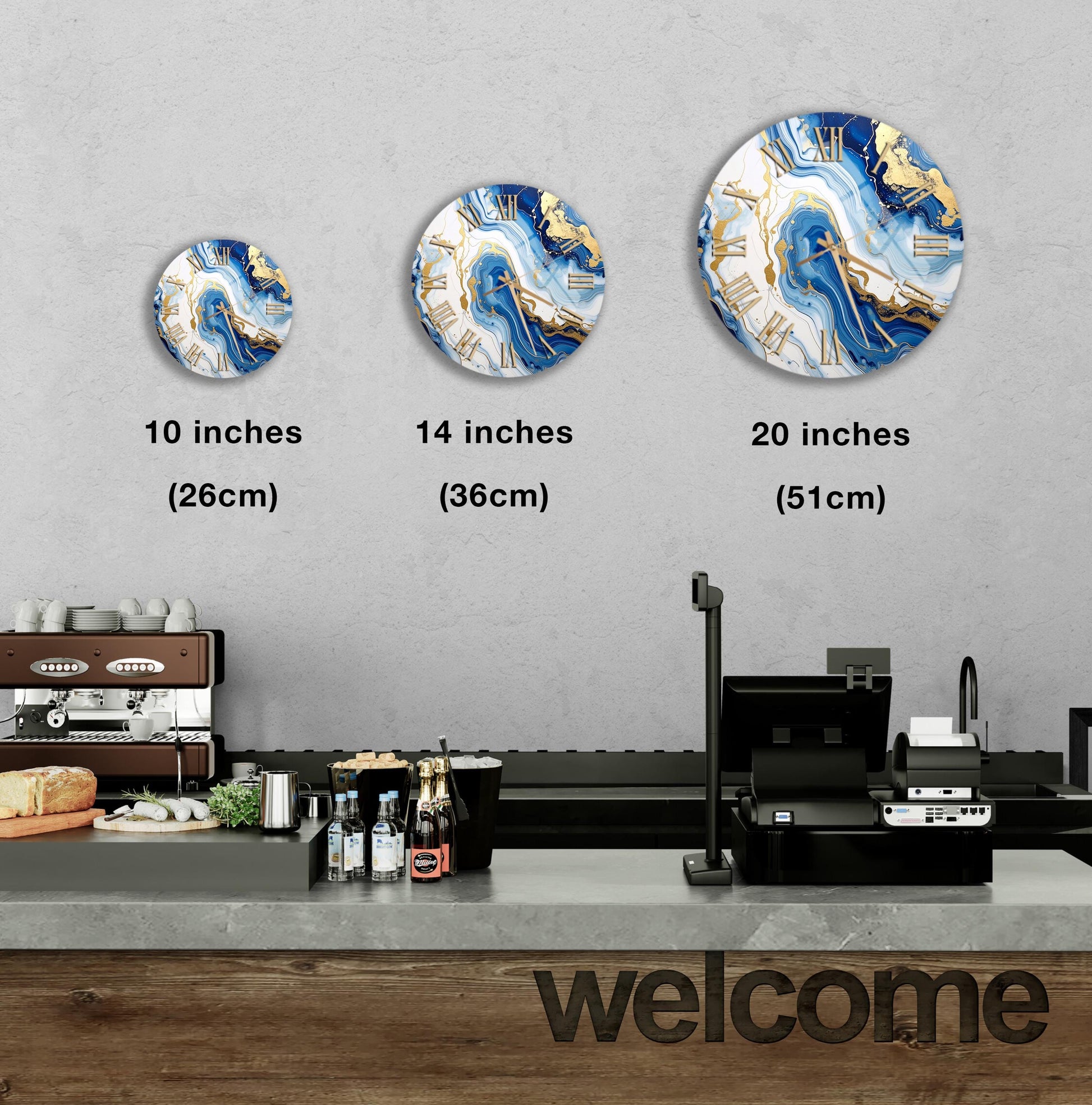 a counter in a restaurant with a "welcome" sign, and three clock designs displayed on the wall above the counter.