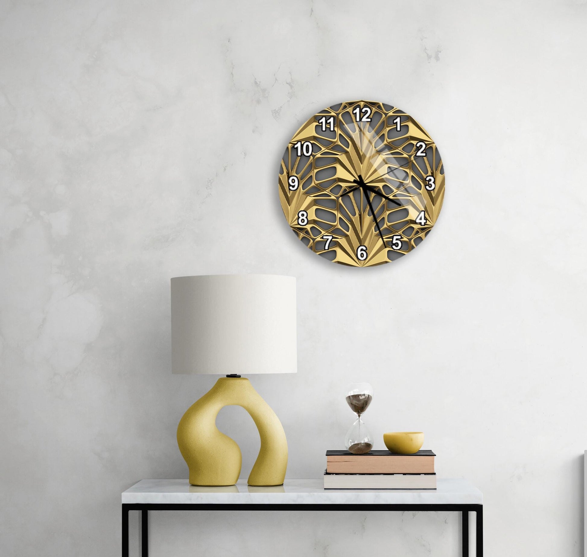 a modern and stylish interior design with a white marble wall, a round gold and black clock, a yellow lamp, a white table, and a stack of books.
