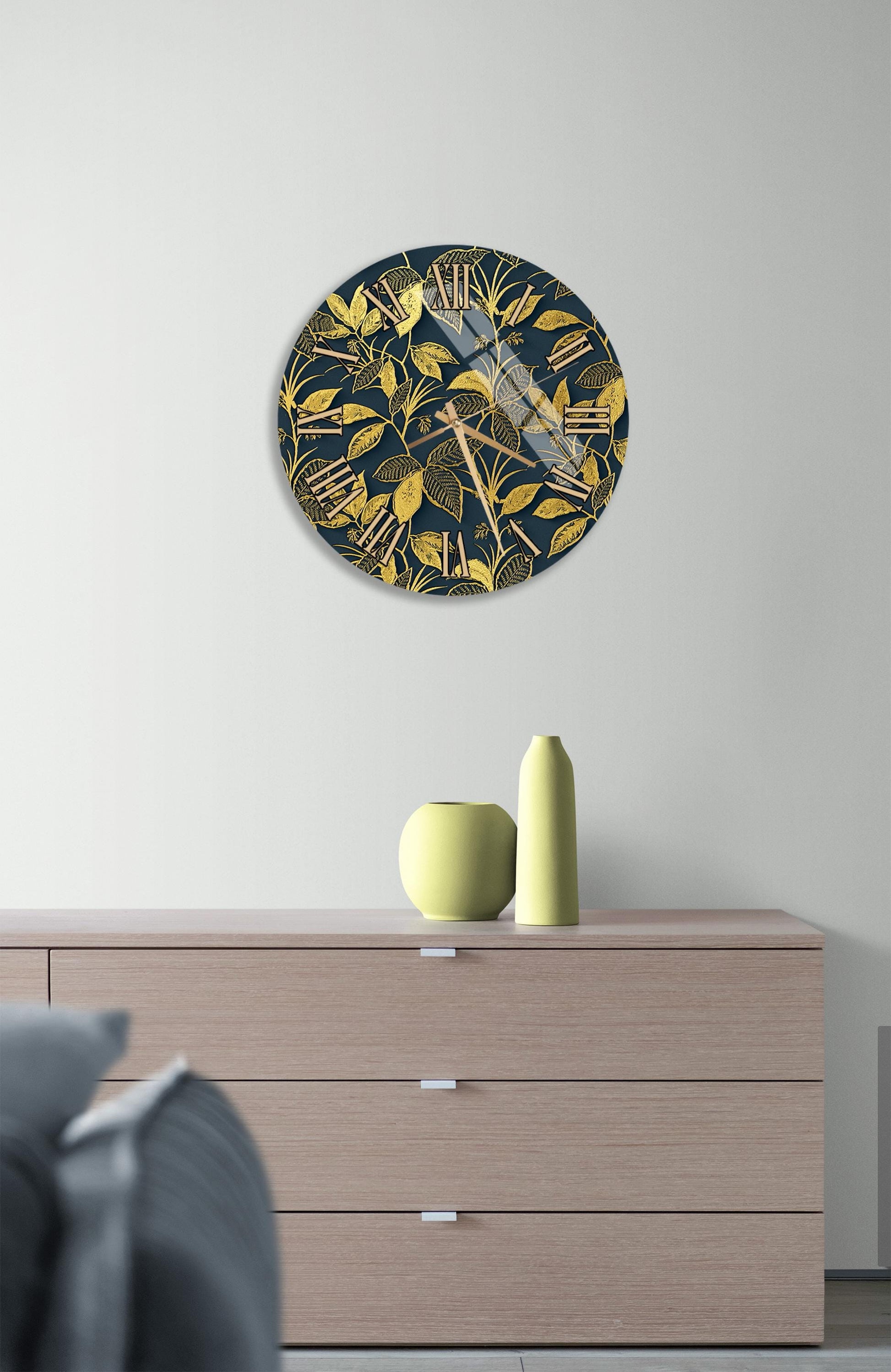 a modern living room with a wooden dresser, a round clock with a gold and blue floral design, and a yellow vase on the dresser.