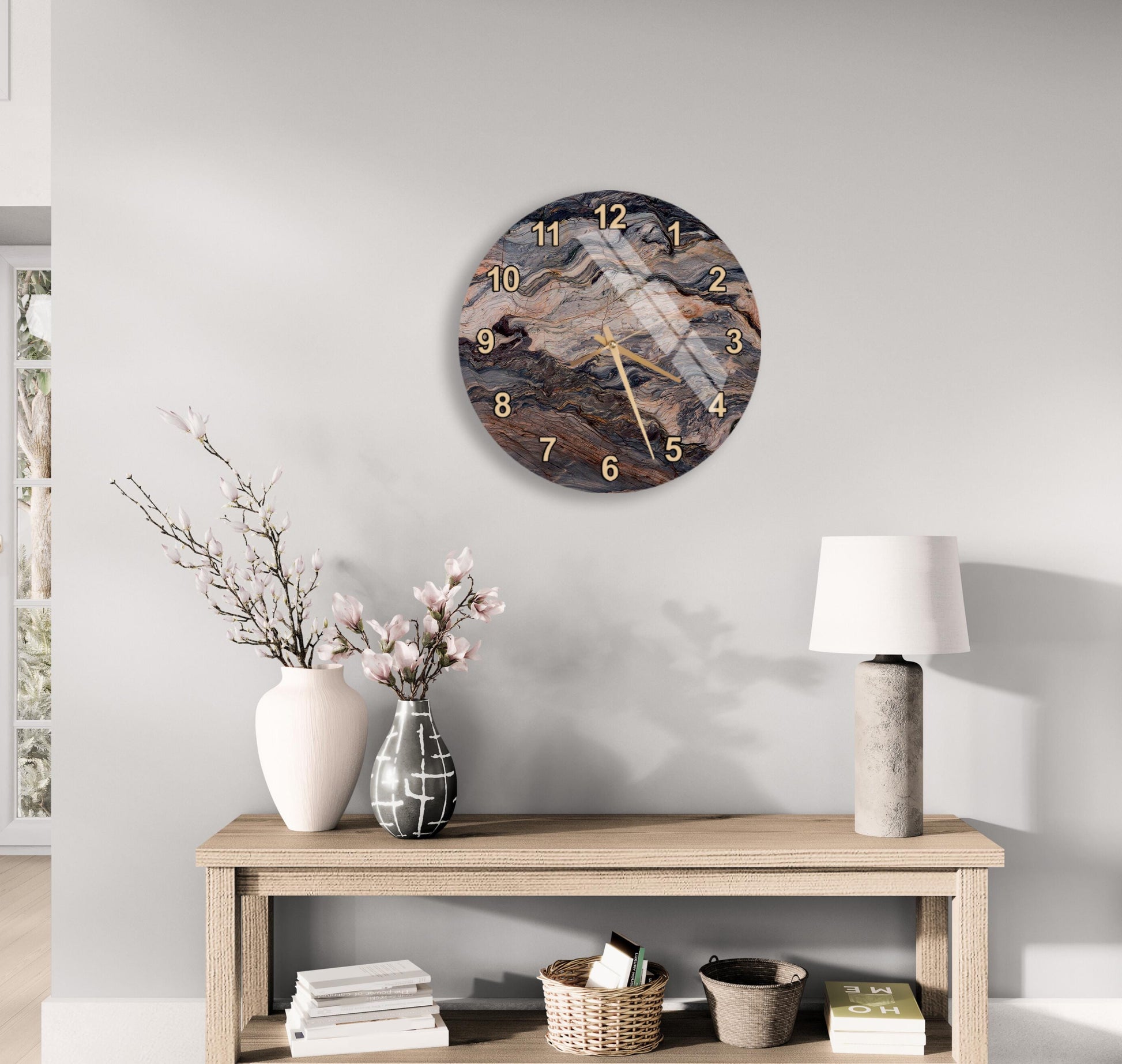 a modern interior design with a wooden table, a round wall clock, and various decorative elements such as a vase with flowers, a lamp, and a stack of books.