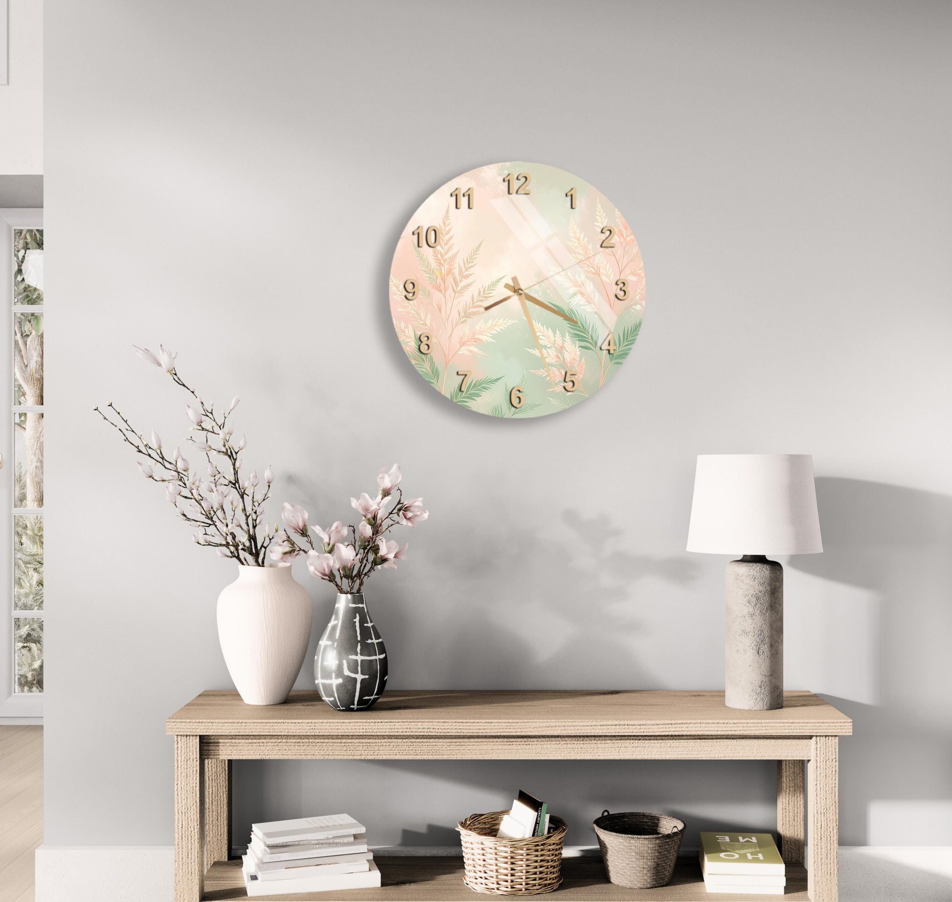 a wall clock with a floral design, a wooden table with a lamp, a vase with flowers, and some books on a shelf.