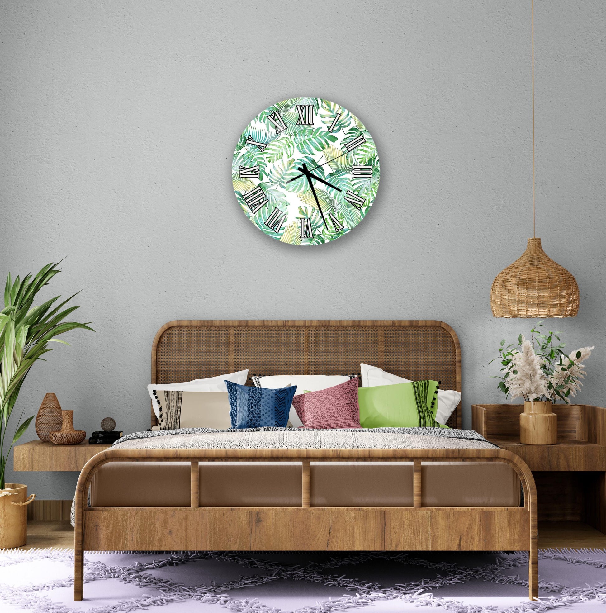 a bedroom with a large bed, a wicker headboard, and a wall clock with a tropical leaf pattern. The room has a neutral color scheme with a wicker pendant light and a woven basket.