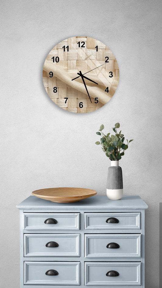 a light blue wooden dresser with a round clock hanging above it, a wooden plate on the dresser, and a vase with greenery on the dresser.