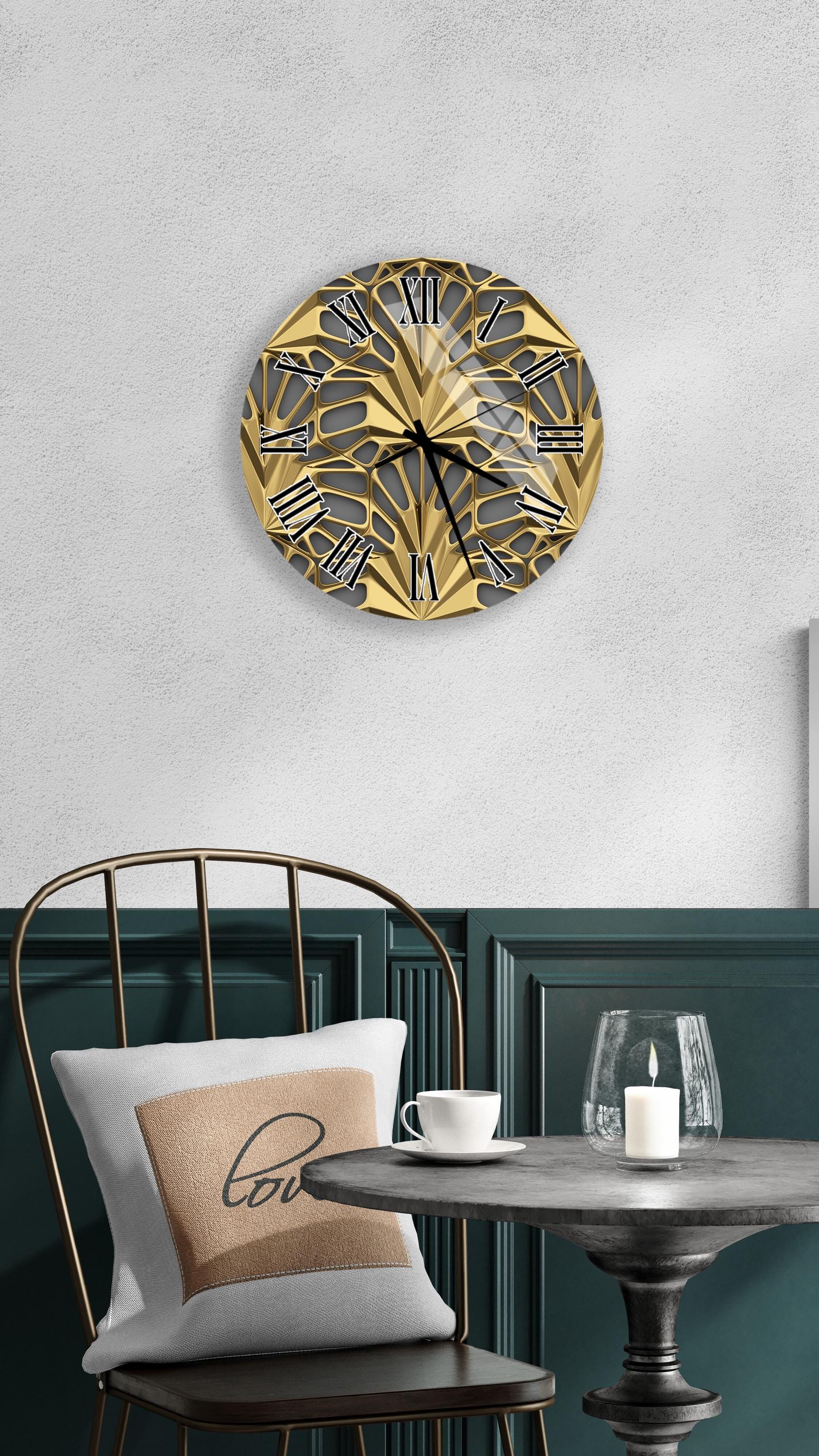 a modern and elegant living space with a gold-colored wall clock, a white table with a candle, and a black chair.