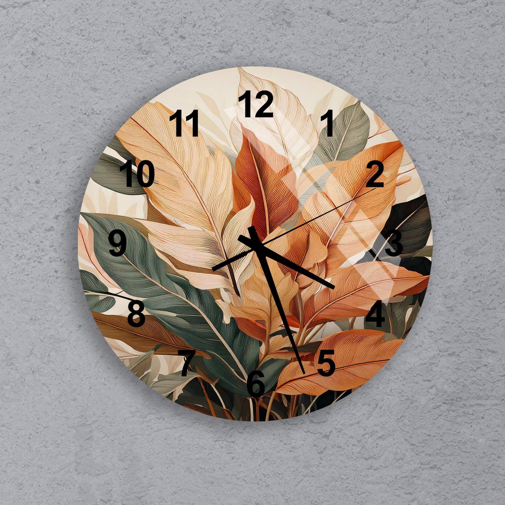 a clock with a painting of leaves on it