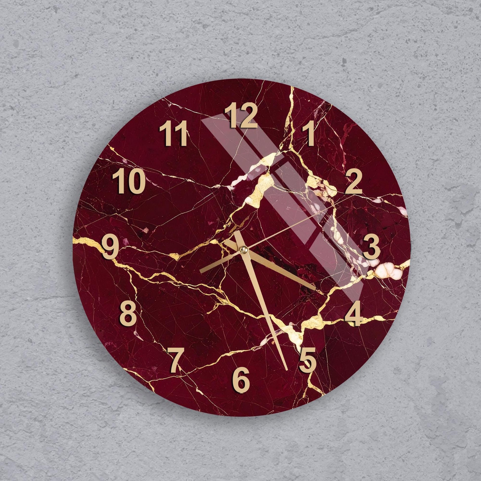 A round wall clock with a maroon and gold color scheme, featuring a cracked and aged appearance.