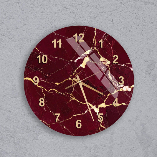 A round wall clock with a maroon and gold color scheme, featuring a cracked and aged appearance.