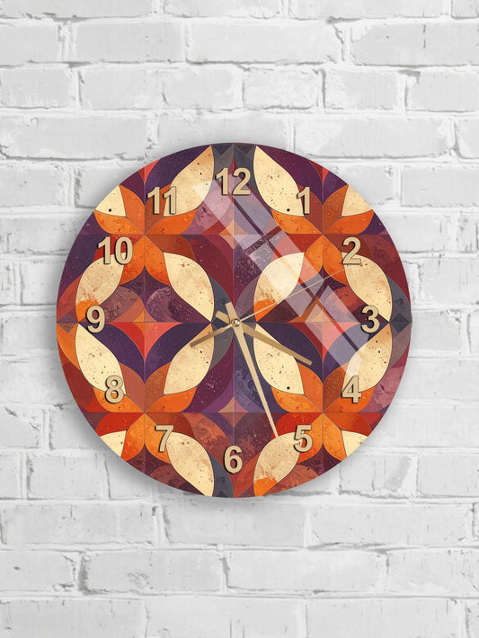 A wall clock with a colorful, abstract design featuring various shapes and patterns in shades of orange, purple, and red.