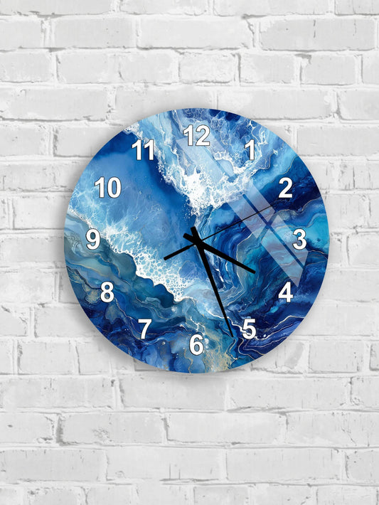 A wall clock with a blue and white marble design, mounted on a white brick wall.