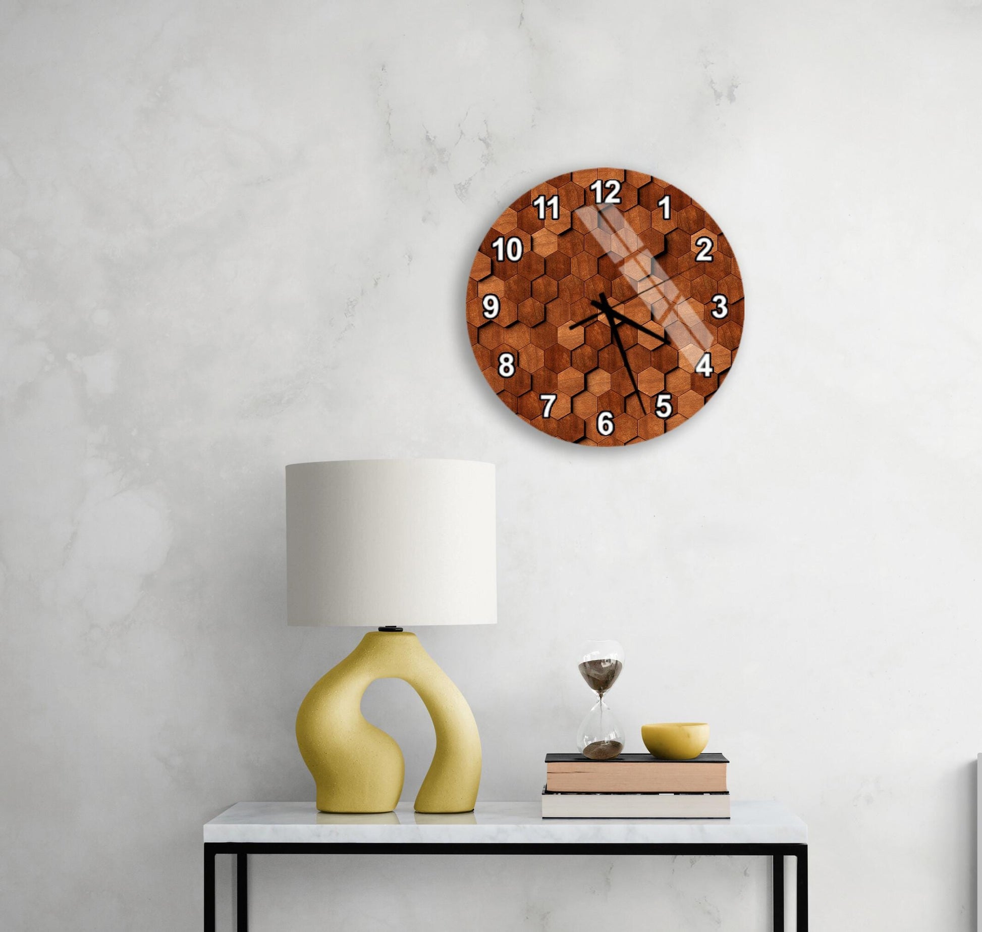 a modern wall clock with a wooden texture, a yellow lamp with a unique curved base, and a small table with a book and a glass of wine.