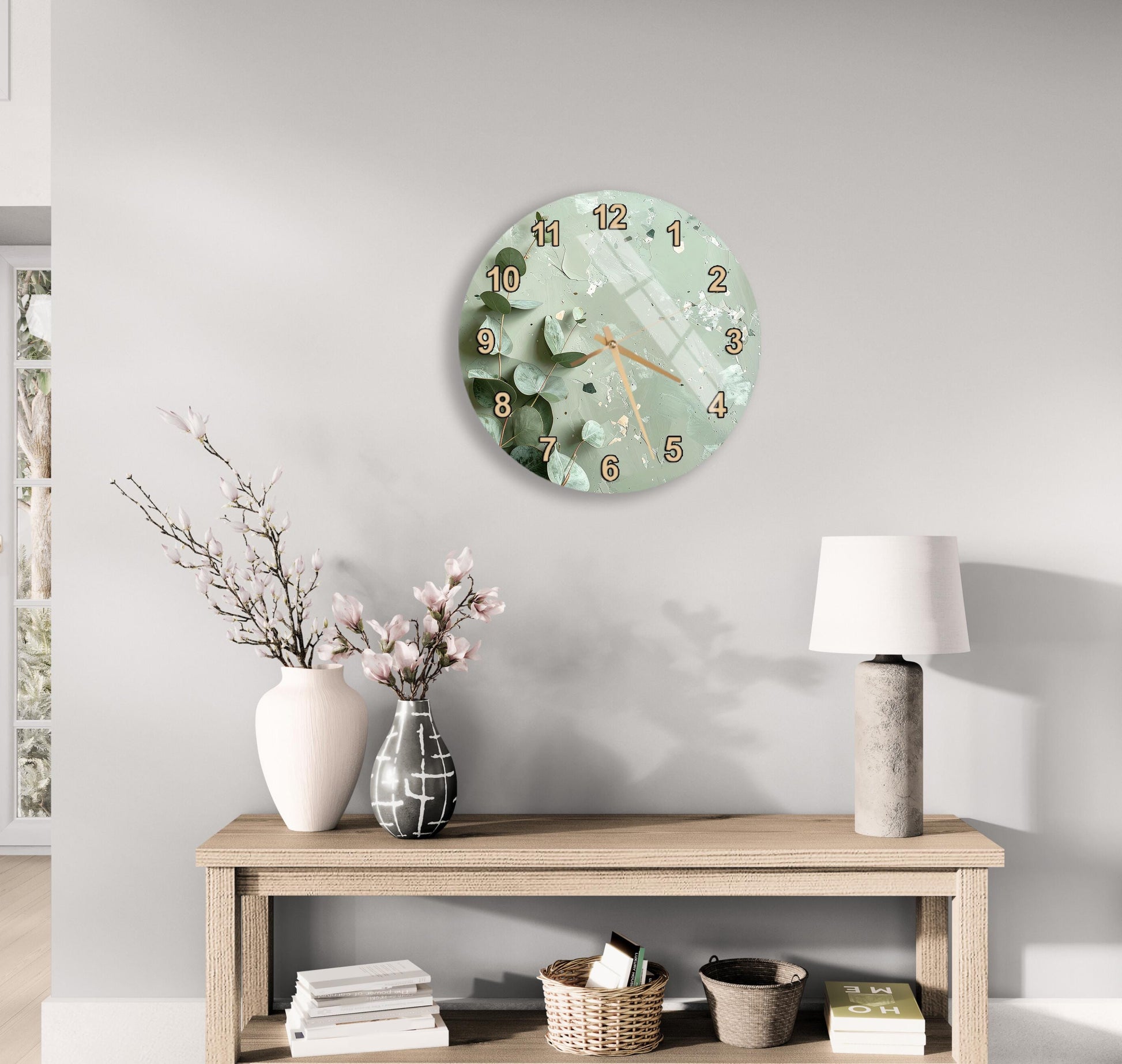 a modern living room with a round wall clock, a wooden table with a lamp, a vase with flowers, and a stack of books.