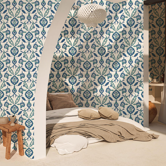 a cozy bedroom with a bed, a wooden stool, and a patterned wallpaper.