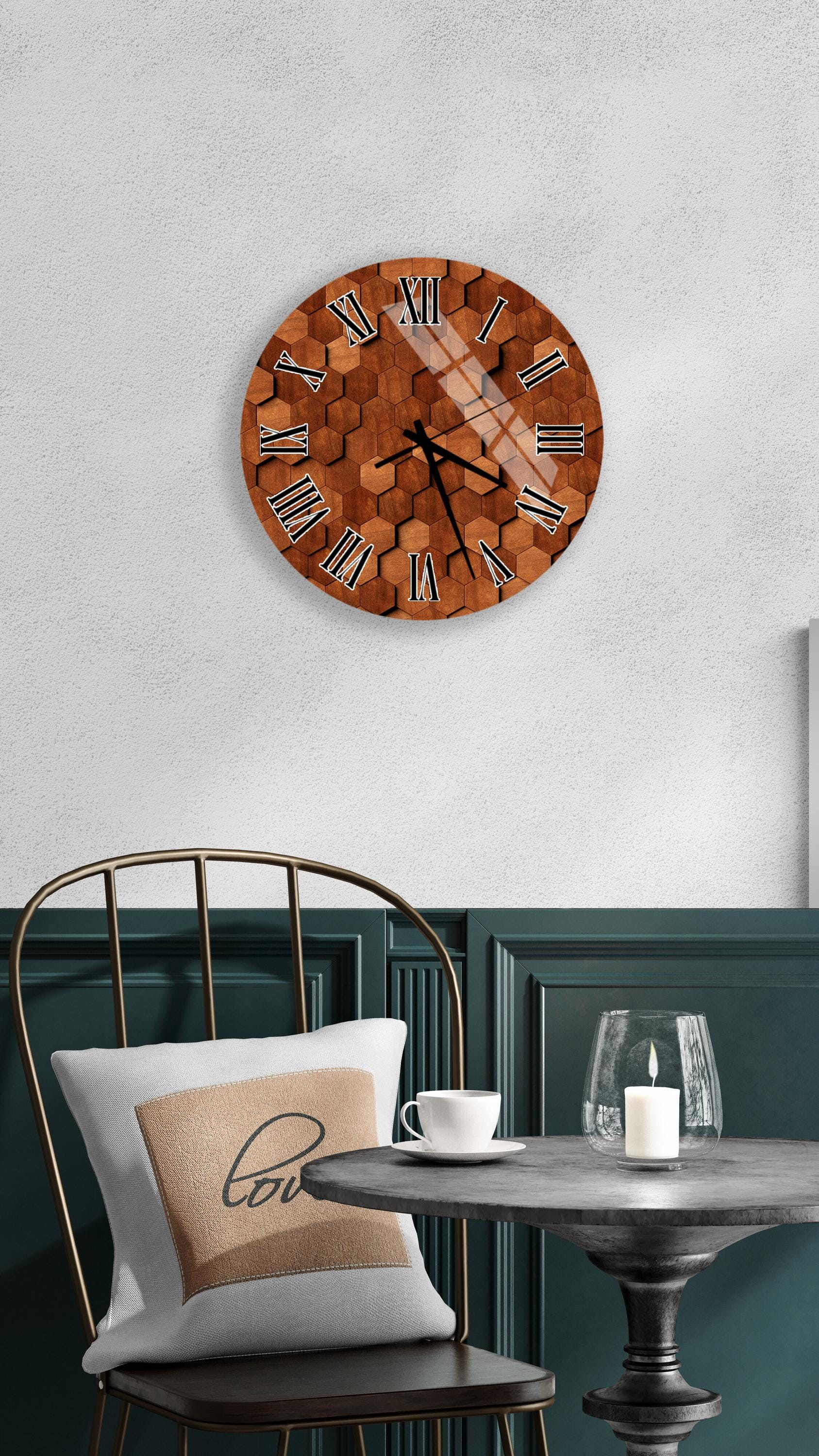 a wall clock with a wooden honeycomb design, a white table with a candle and a cup, and a black chair with a white pillow.