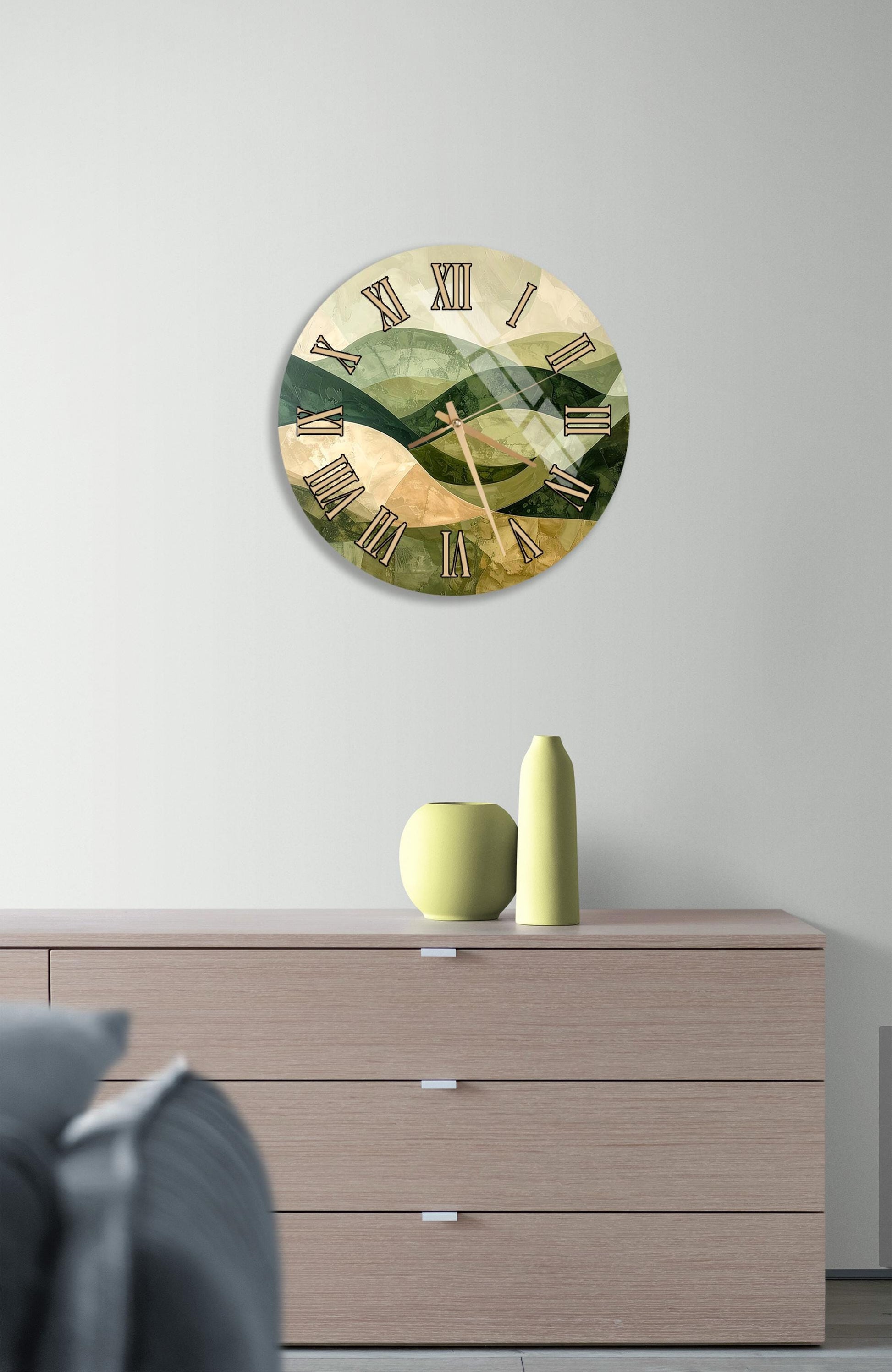 a wall clock with a green and brown color scheme, mounted on a wall above a wooden dresser with three drawers.