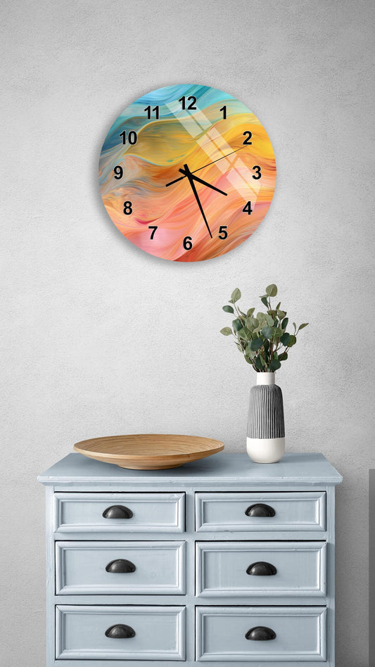 a wall clock with a colorful abstract design, a wooden tray, a vase with greenery, and a gray dresser with six drawers.