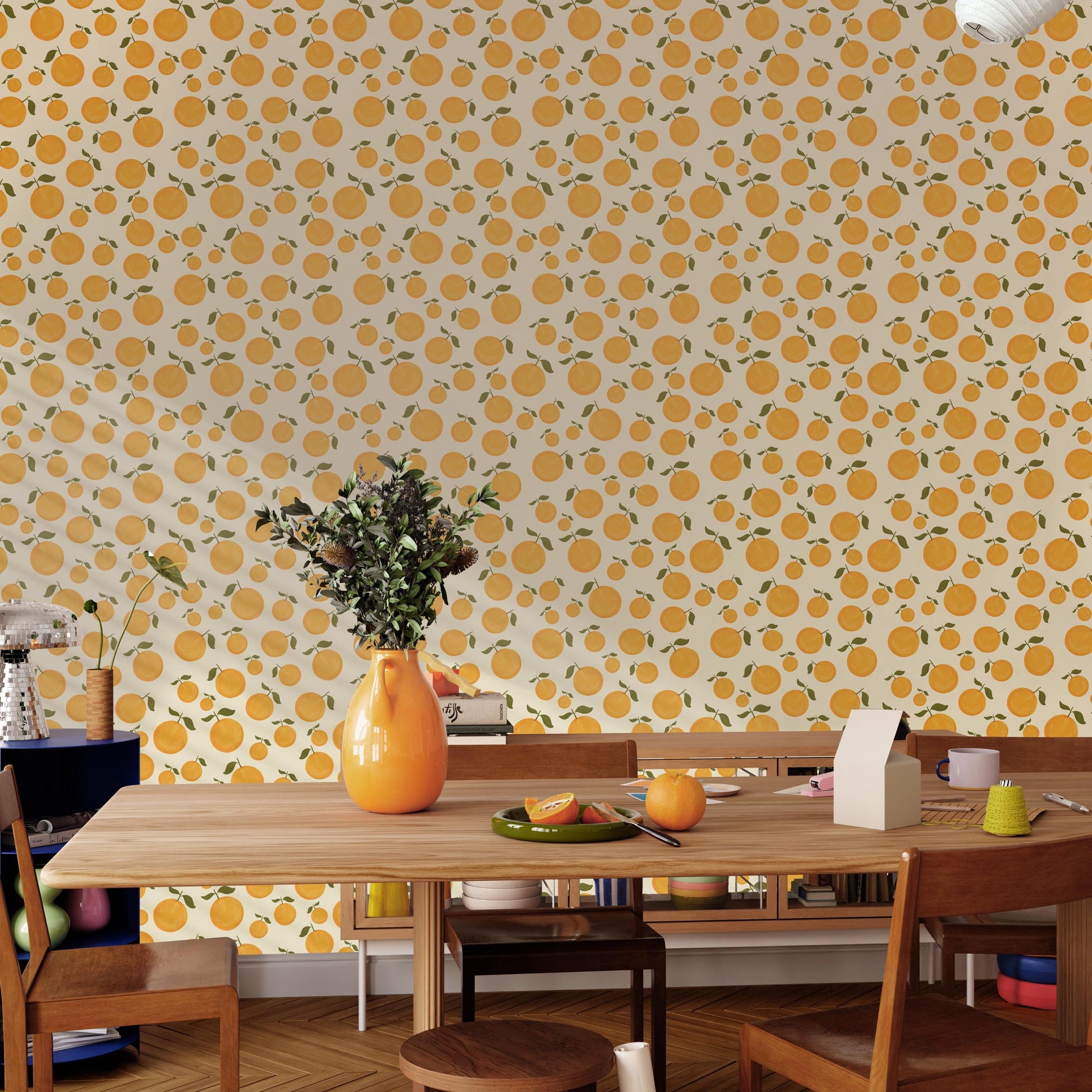 a dining room with a wooden table, chairs, and a vase of flowers. The wall behind the table has a repeating pattern of orange circles, creating a vibrant and lively atmosphere.