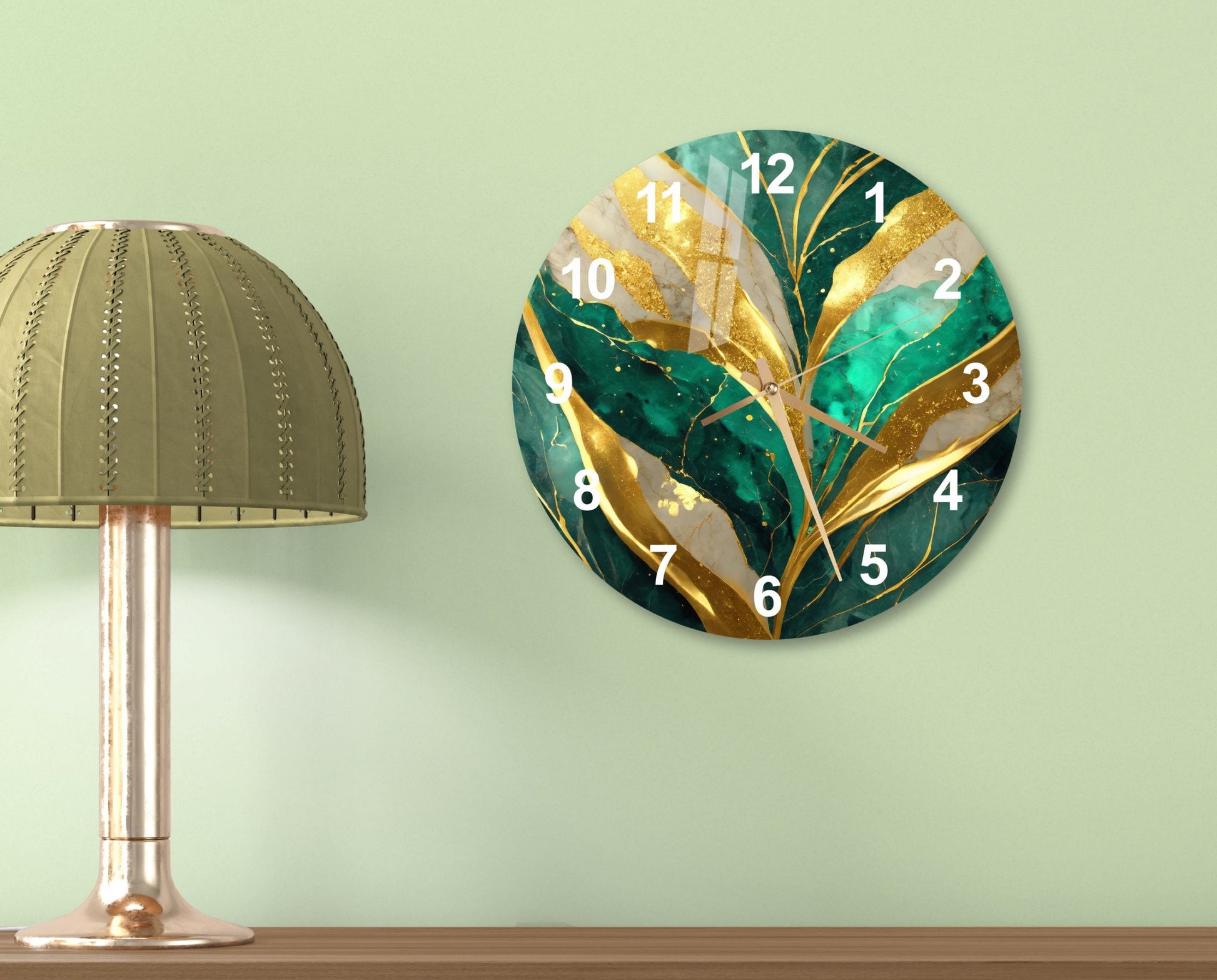 a green and gold clock on a wall next to a lamp